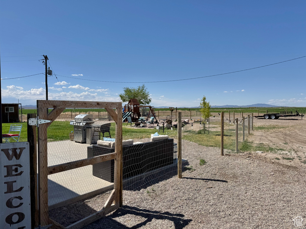 View of yard featuring a rural view and a playground