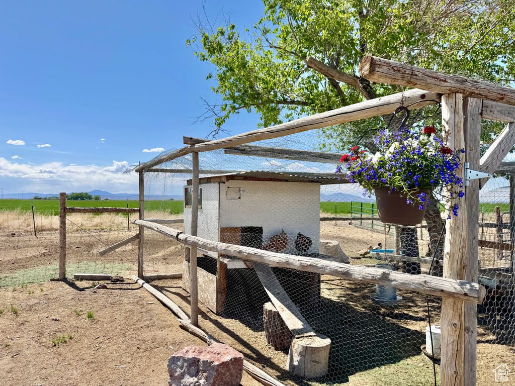 View of yard featuring exterior structure, an outbuilding, and a rural view