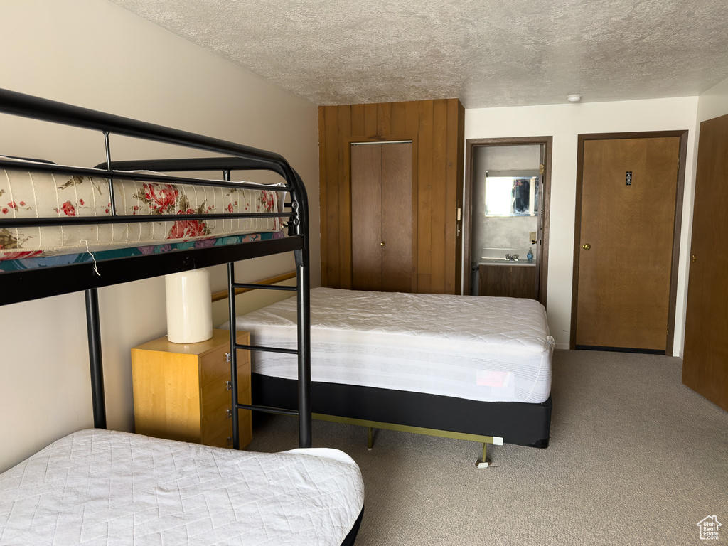 Unfurnished bedroom with carpet and a textured ceiling