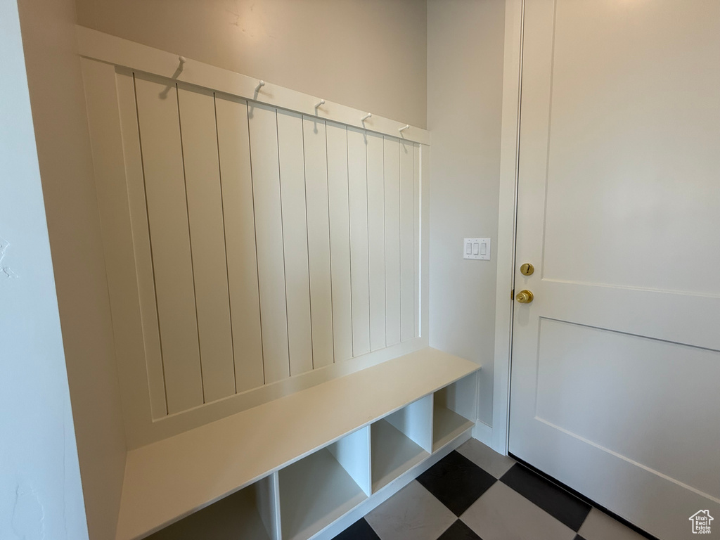 Mudroom featuring dark floors