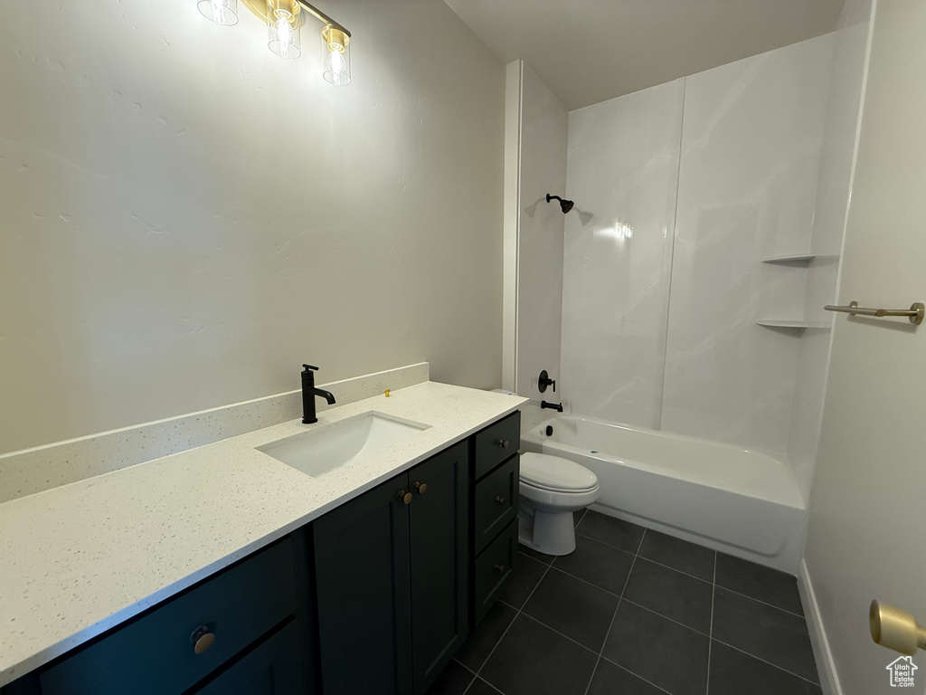 Full bathroom with tile patterned floors, vanity, toilet, and shower / bath combination