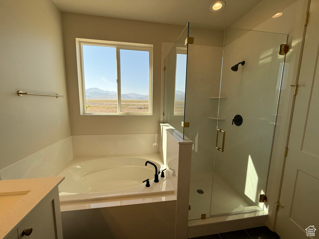 Full bath featuring a garden tub, a shower stall, vanity, a mountain view, and recessed lighting