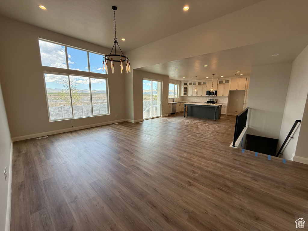 Dining space featuring a chandelier, recessed lighting, dark wood-style flooring, and baseboards