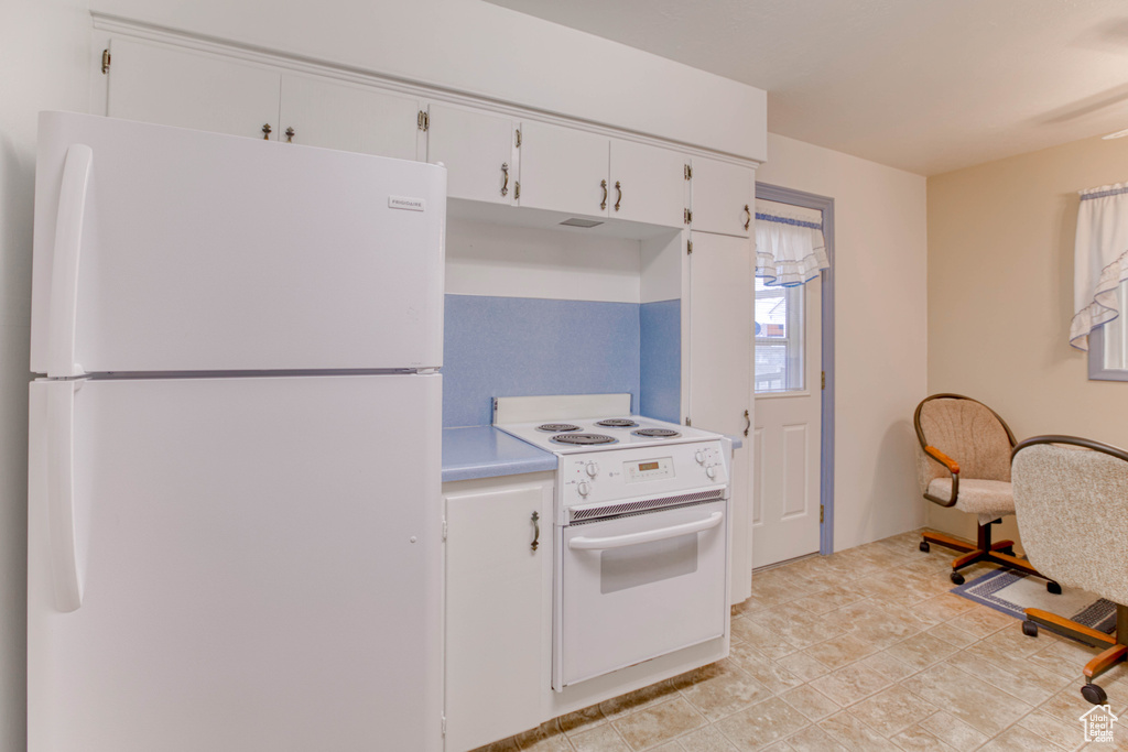 Kitchen with white appliances and white cabinets