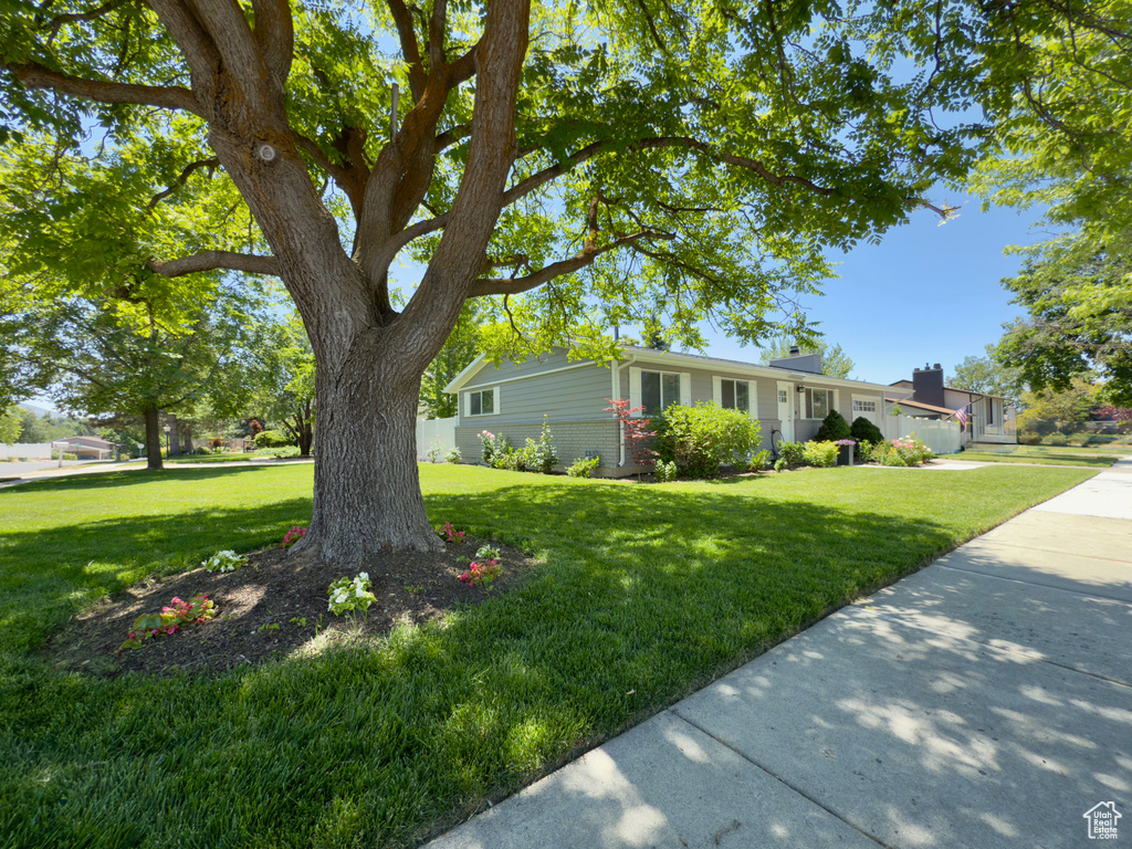 Single story home featuring a front yard and brick siding
