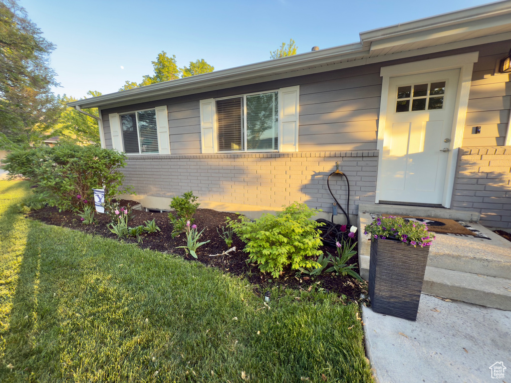 View of front facade with brick siding and a front yard