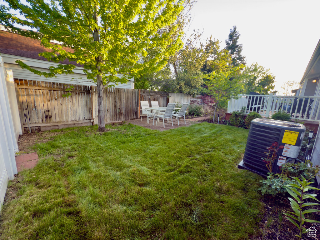 View of yard featuring cooling unit and a patio