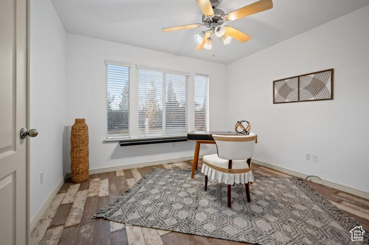 Office with a ceiling fan, wood finished floors, and baseboards