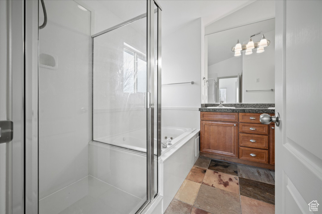 Bathroom with vanity and plus walk in shower