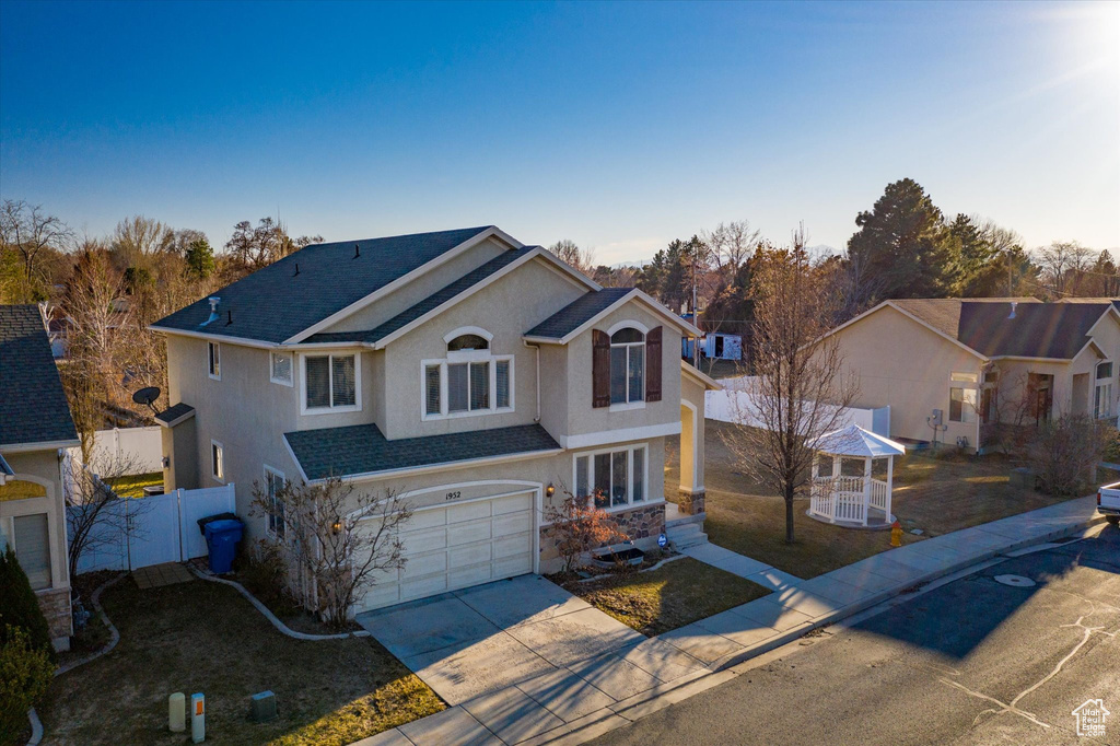 View of front property with a garage and a gazebo