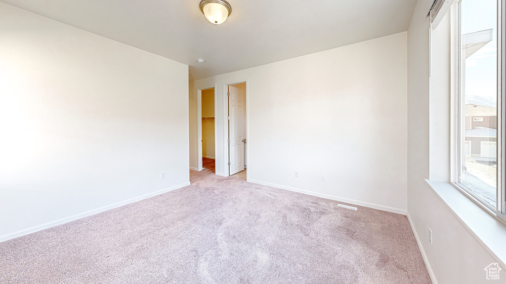 Spare room with light colored carpet