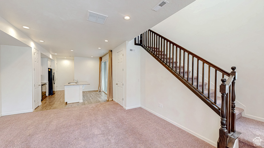 Interior space with sink and light colored carpet