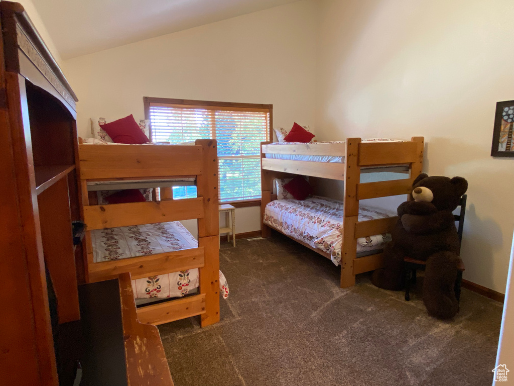 Carpeted bedroom with vaulted ceiling