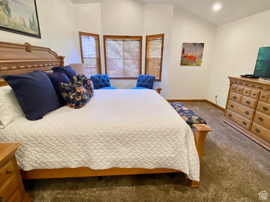 Carpeted bedroom with lofted ceiling