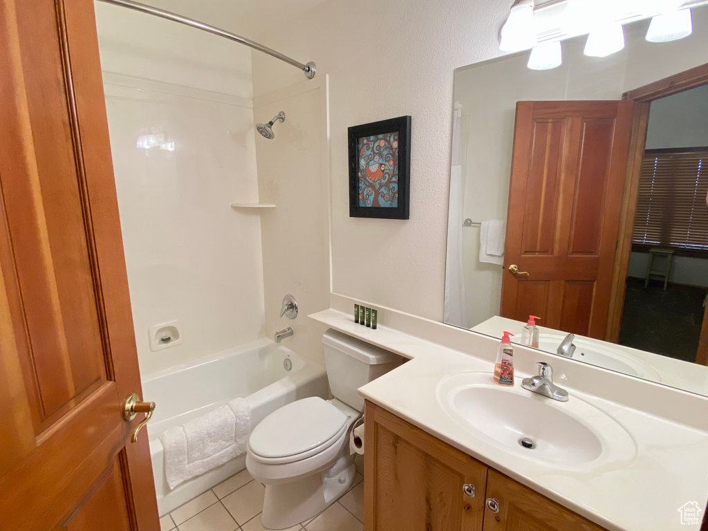 Full bathroom featuring vanity, tile patterned floors, shower / bathtub combination, and toilet