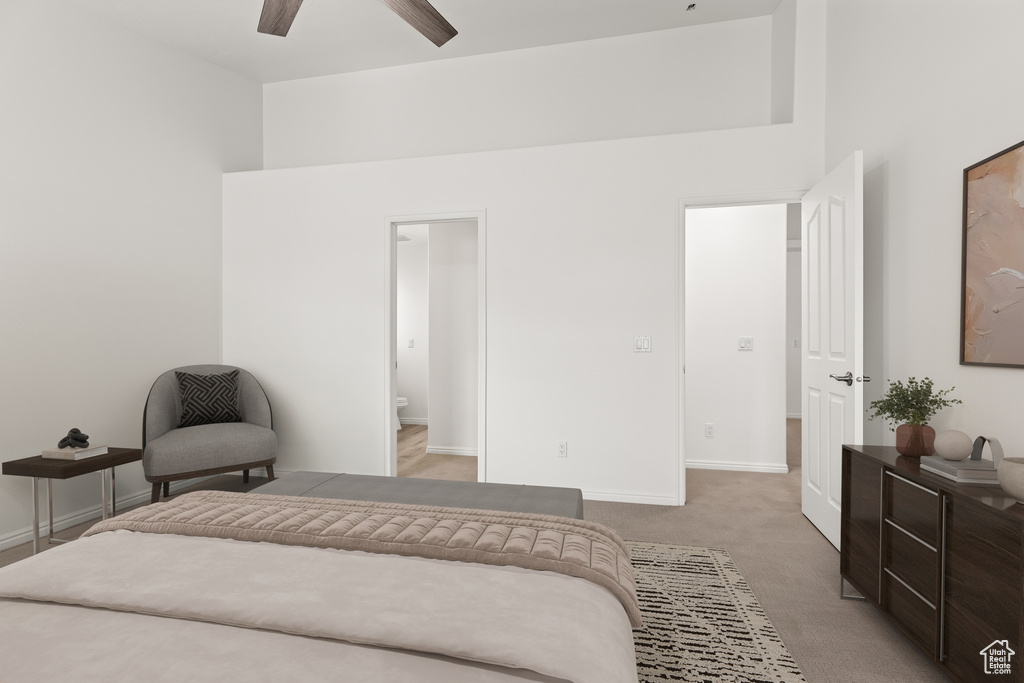 Bedroom featuring baseboards, light carpet, a ceiling fan, and connected bathroom