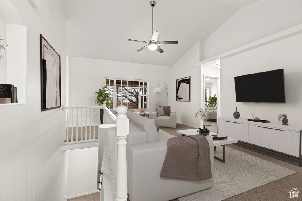 Living area with ceiling fan and high vaulted ceiling