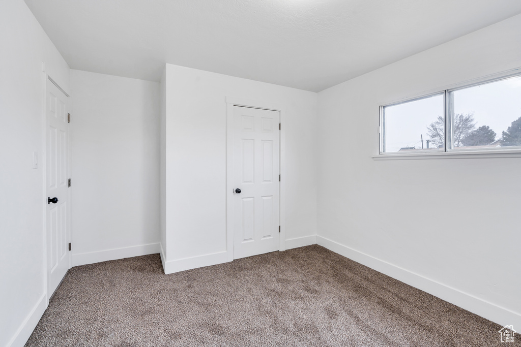 Unfurnished bedroom featuring carpet floors and a closet