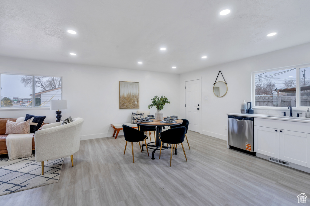 Dining room with light hardwood / wood-style floors and sink