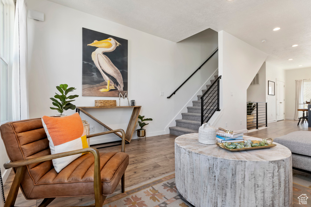 Sitting room with wood-type flooring
