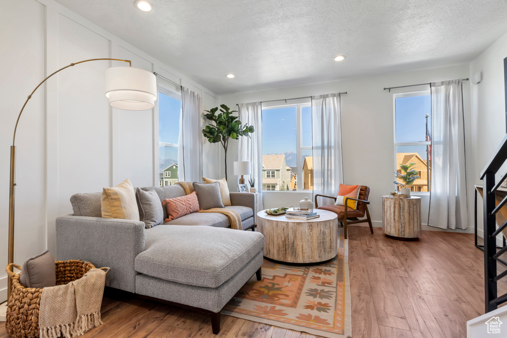 Living room featuring hardwood / wood-style flooring and a textured ceiling