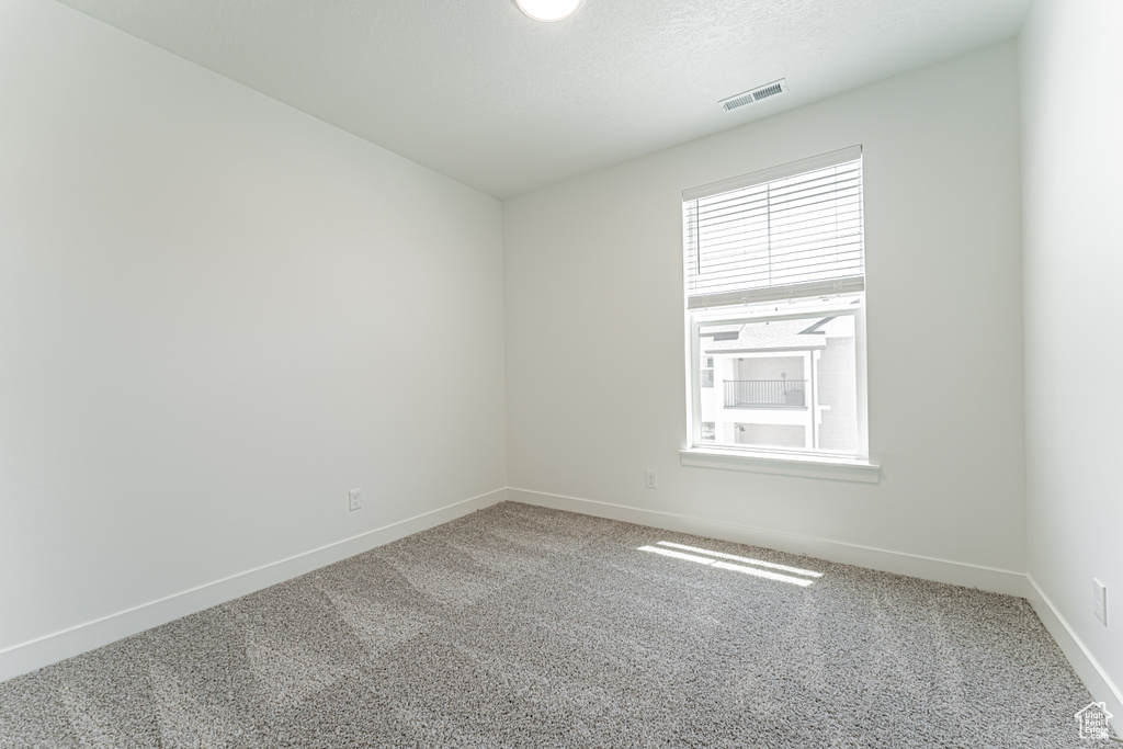Unfurnished room with carpet flooring