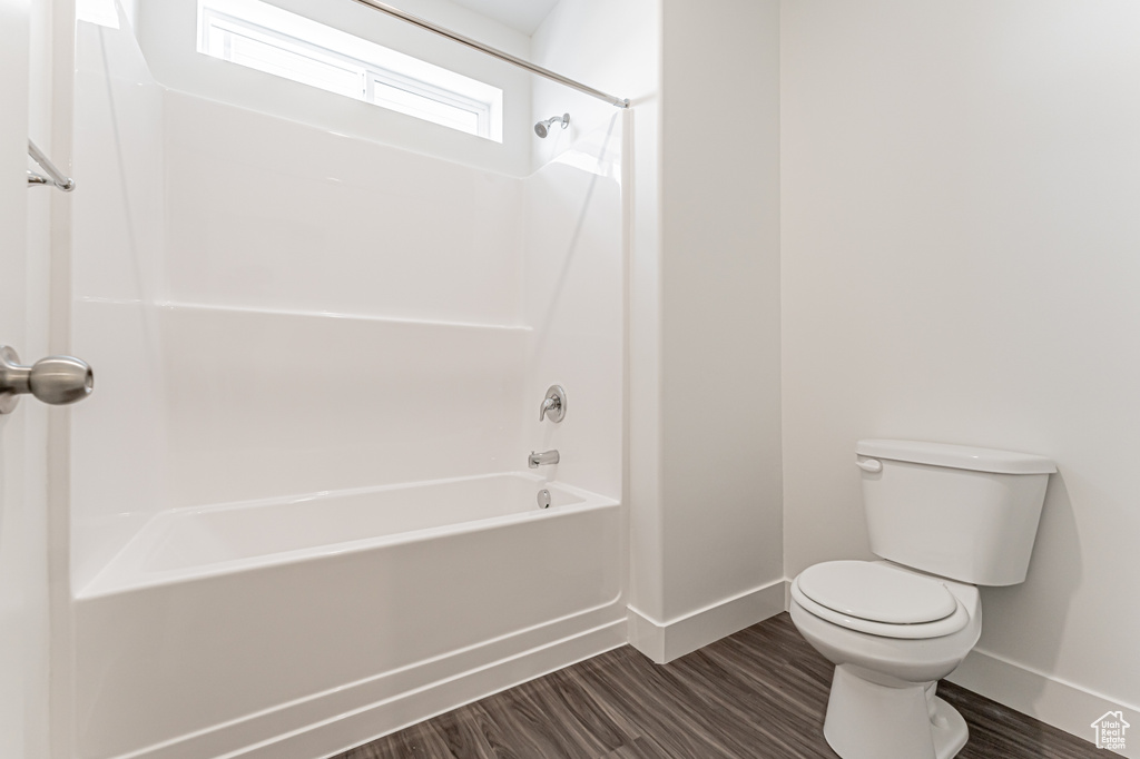 Full bath featuring bathing tub / shower combination and wood finished floors