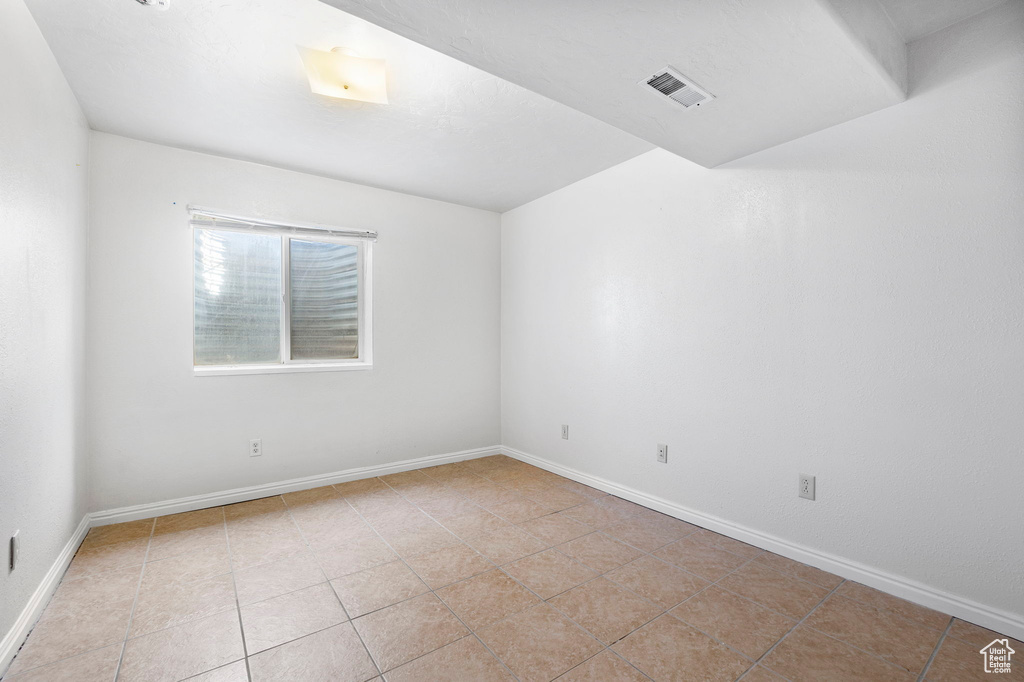 Spare room with light tile patterned floors