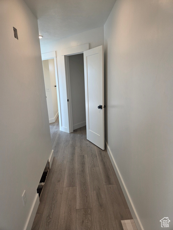 Hall with wood finished floors and baseboards
