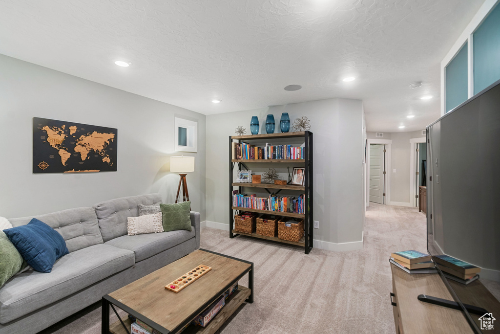 Living room featuring a textured ceiling and light colored carpet