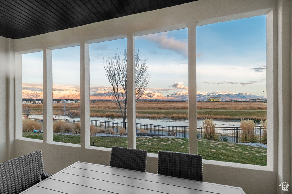Dining area featuring a water and mountain view