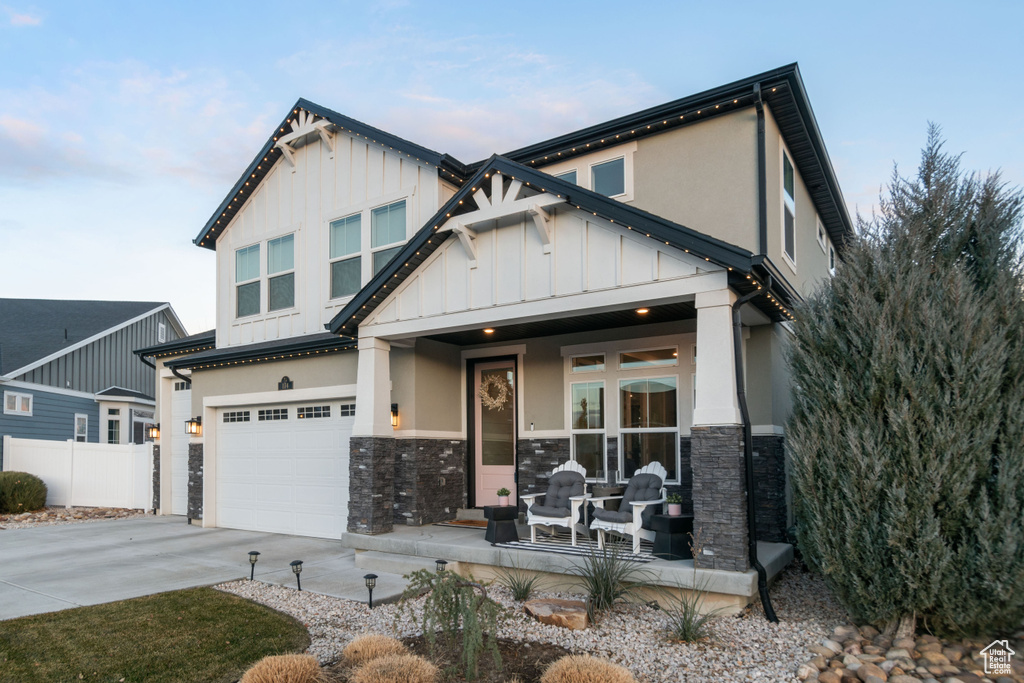 Craftsman-style house featuring a garage and covered porch