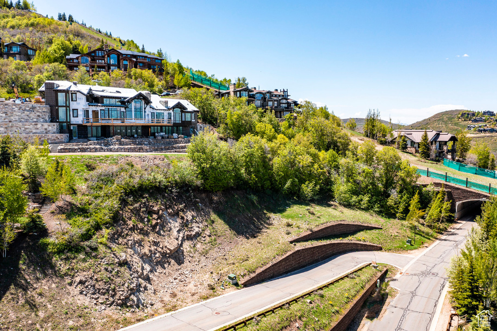 Aerial view of property and surrounding area with a mountainous background and a pool
