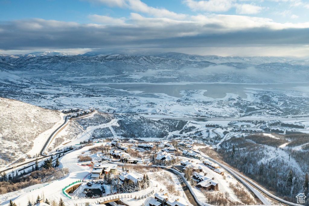 Snowy aerial view with a mountain view and a residential view