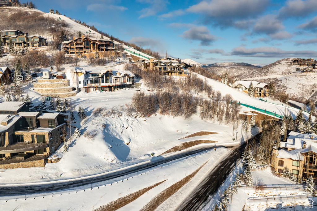 Snowy aerial view with a residential view and a mountain view