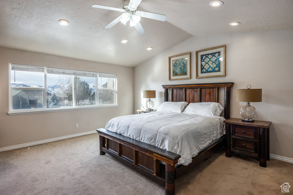 Carpeted bedroom with a textured ceiling, baseboards, recessed lighting, lofted ceiling, and a ceiling fan