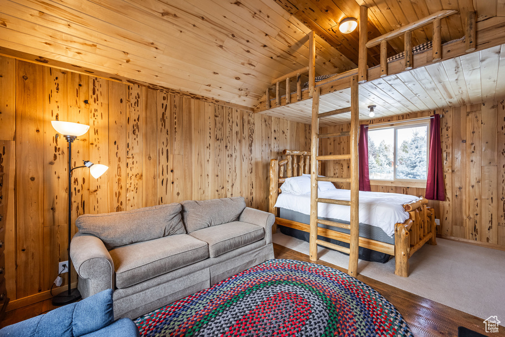 Bedroom featuring wood ceiling, wood walls, and wood finished floors