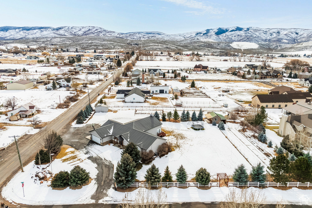 Snowy aerial view with a mountain view and a residential view