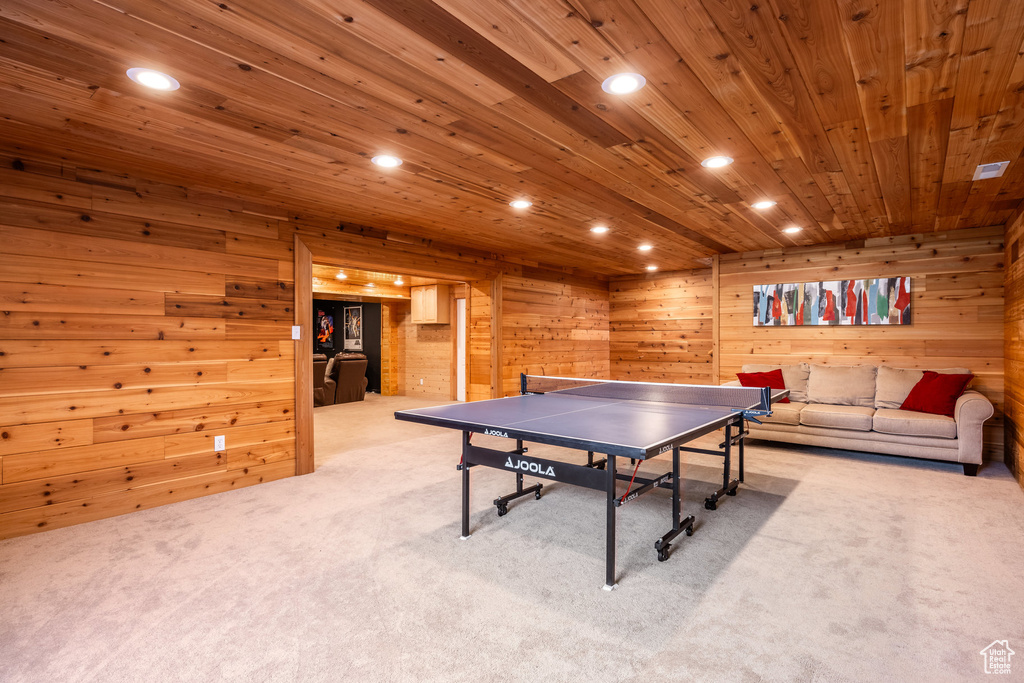 Playroom with carpet floors, wooden ceiling, wooden walls, and recessed lighting
