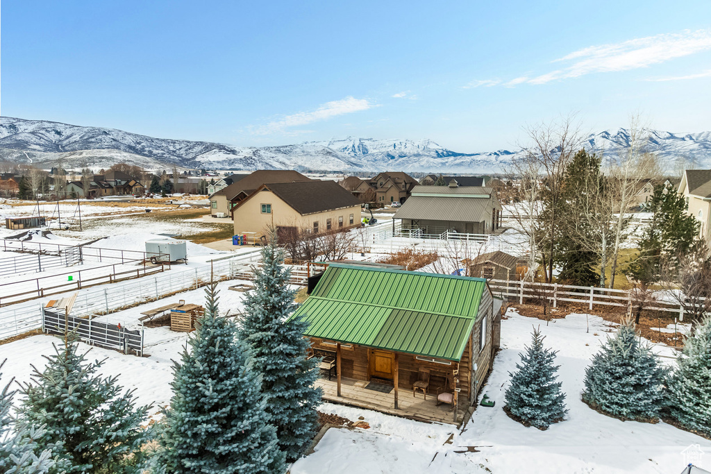 Snowy aerial view with a mountain view and a residential view