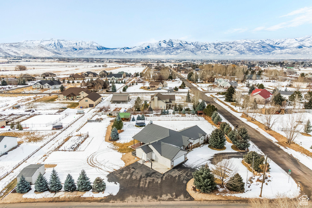 Snowy aerial view with a residential view and a mountain view