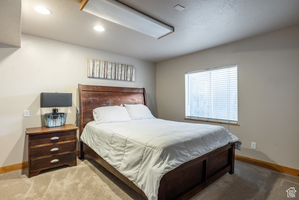Bedroom featuring baseboards, carpet floors, and recessed lighting