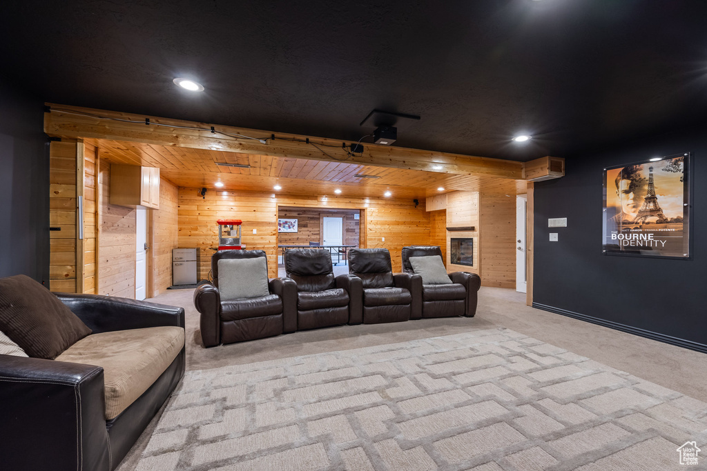 Cinema with wood walls, carpet, and recessed lighting