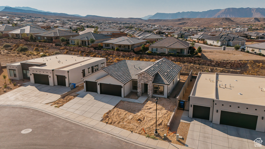 Aerial perspective of suburban area with a mountainous background