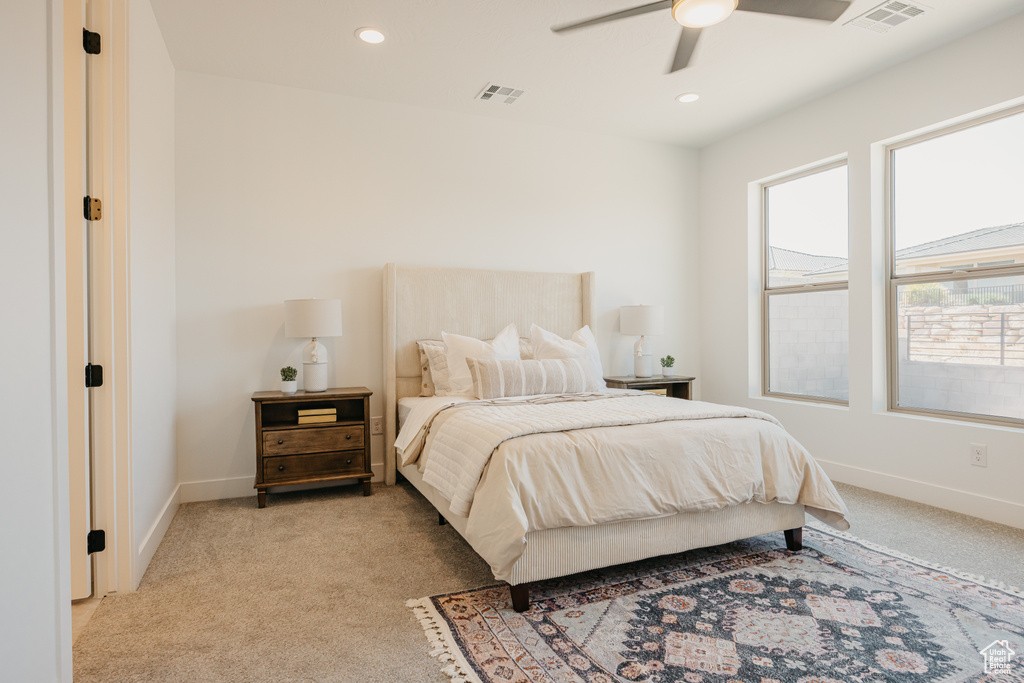 Bedroom with light carpet, recessed lighting, and a ceiling fan