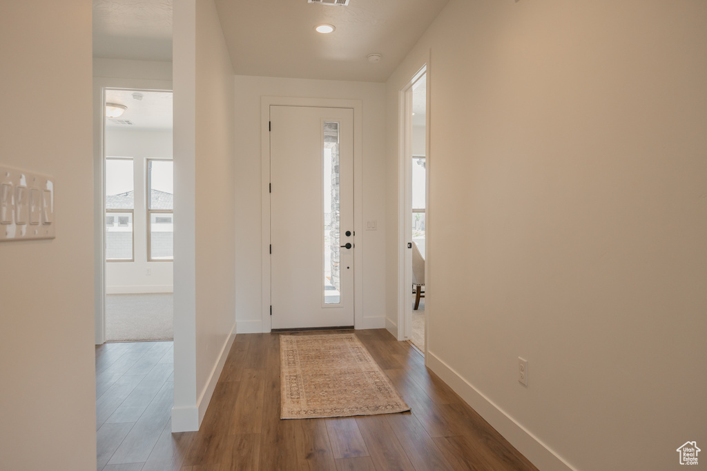 Entrance foyer featuring dark wood-type flooring and baseboards