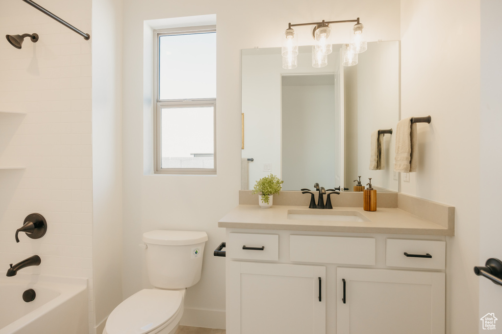 Full bath featuring vanity, plenty of natural light, and shower / tub combination