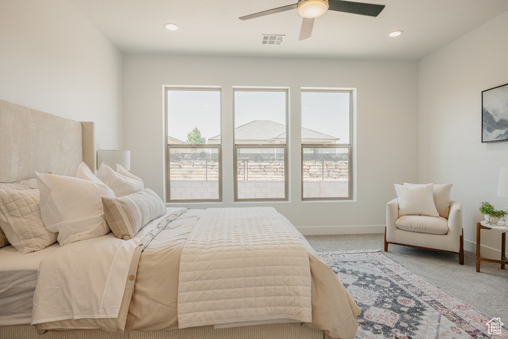 Carpeted bedroom featuring ceiling fan and recessed lighting