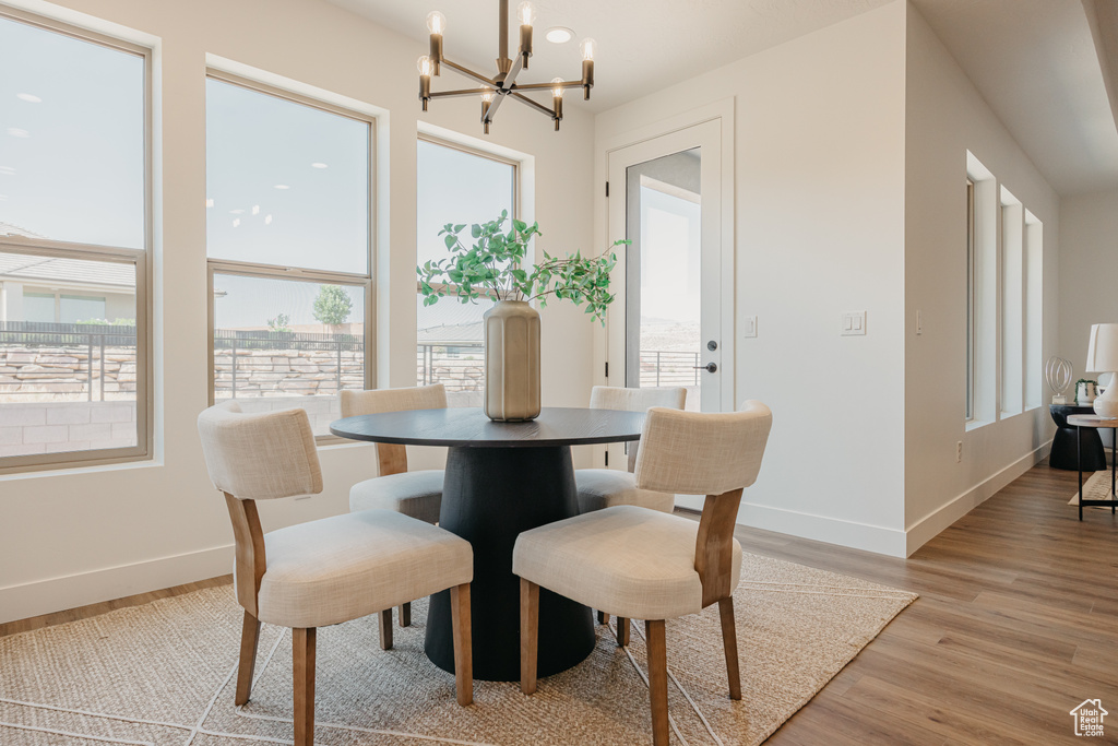 Dining space featuring a chandelier and light wood-type flooring