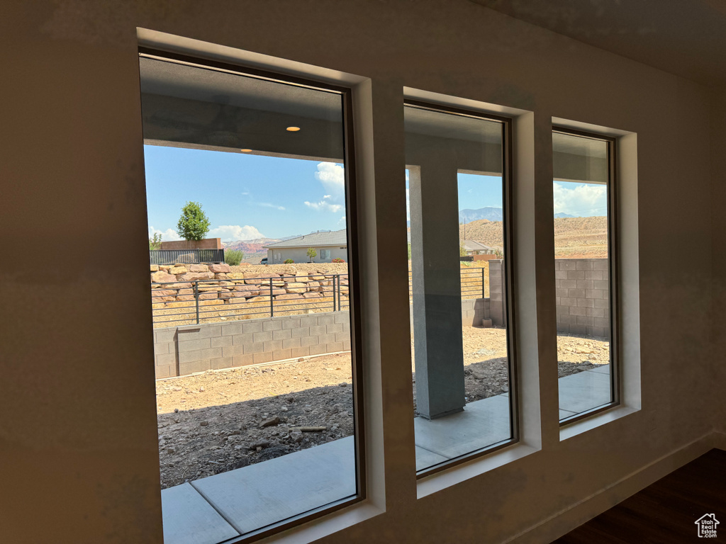 Doorway to outside with wood finished floors and baseboards